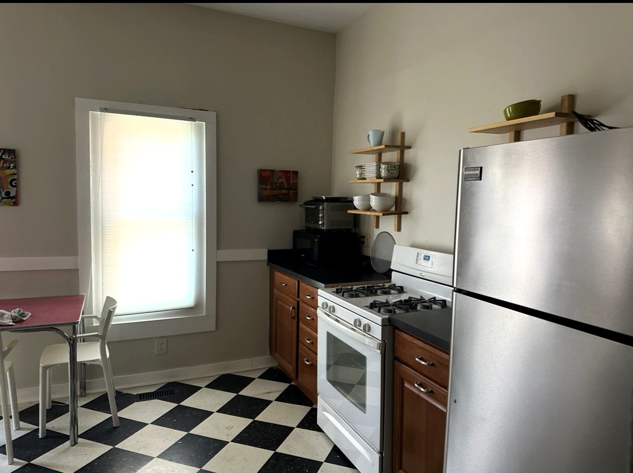 Eat-in kitchen with gas range and checkerboard floor